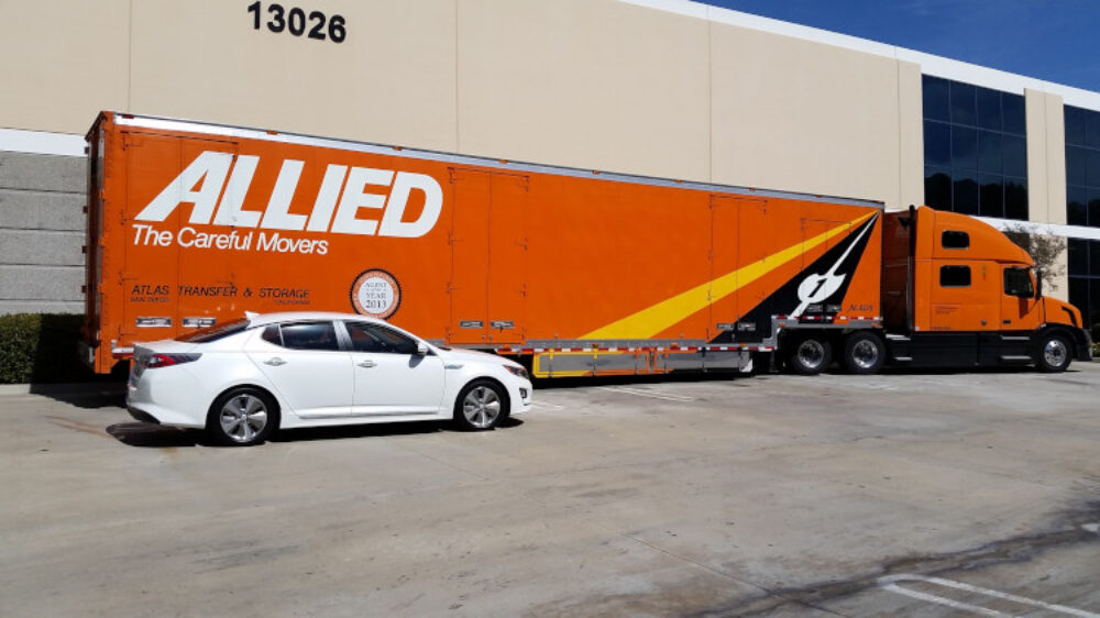 Interstate truck next to a mid-sized car