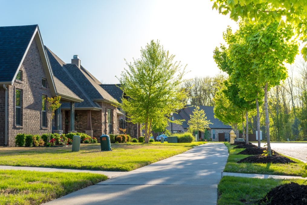 View of modern residential houses neighborhood street in Bentonville, Northwest Arkansas, sunny flare day, fast growing city lifestyle