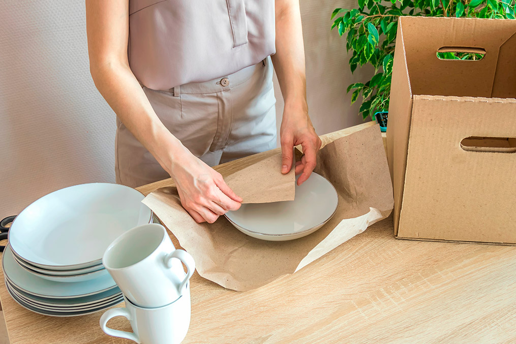 a woman packing dishes