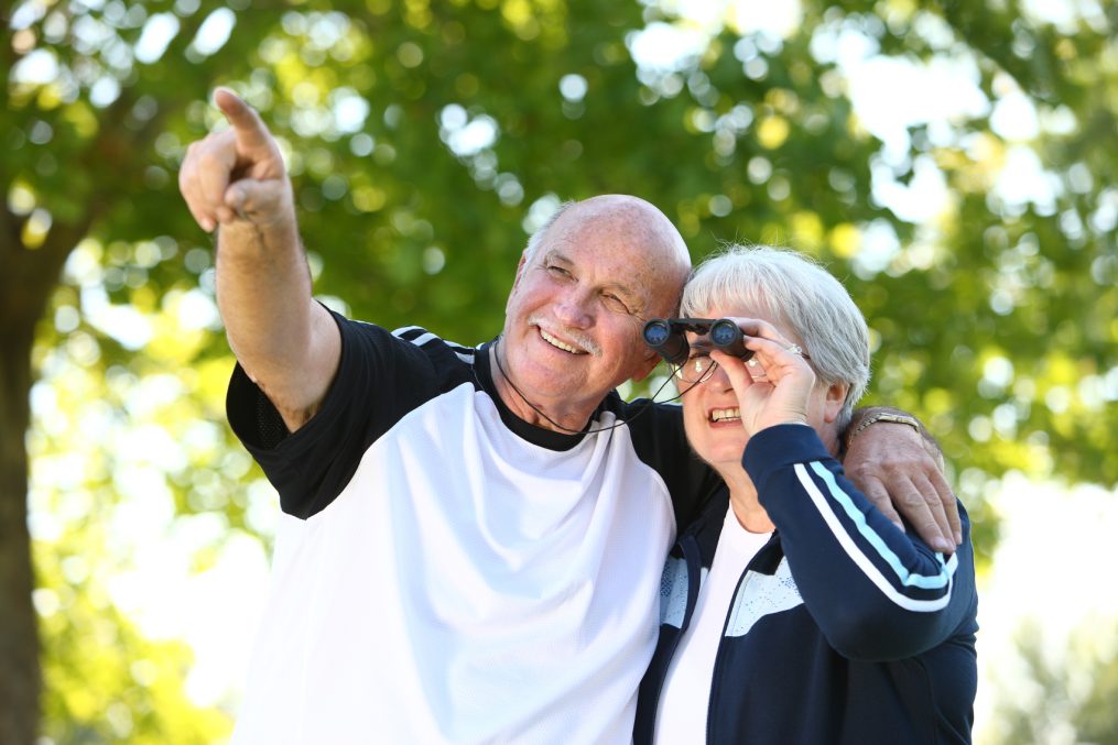 Senior couple looking through binoculars