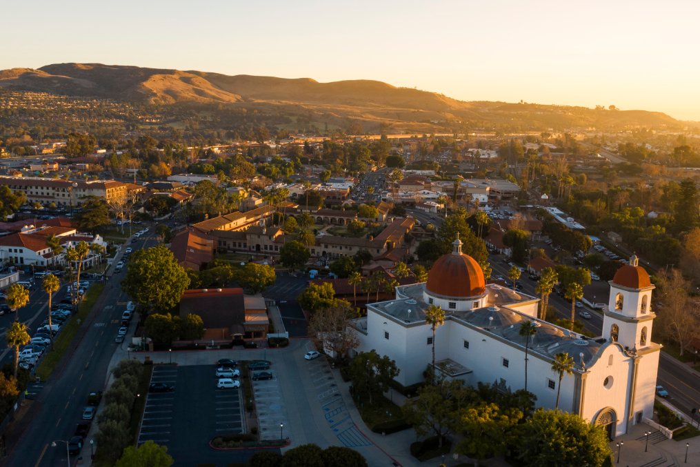 Sunset aerial view of the Spanish Colonial era mission and surrounding city of downtown San Juan Capistrano, California, USA.