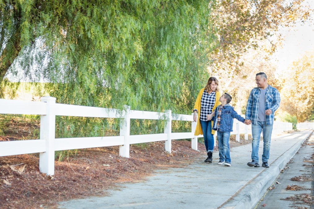 Mixed Race Family Taking A Walk Outdoors.