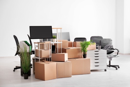 Carton boxes with stuff in empty room