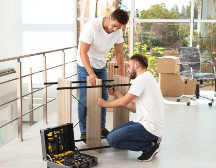Professional workers disassembling rack.