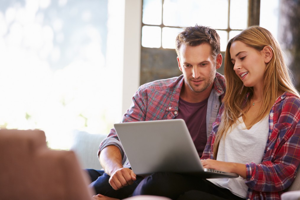 Couple At Home Planning Move.