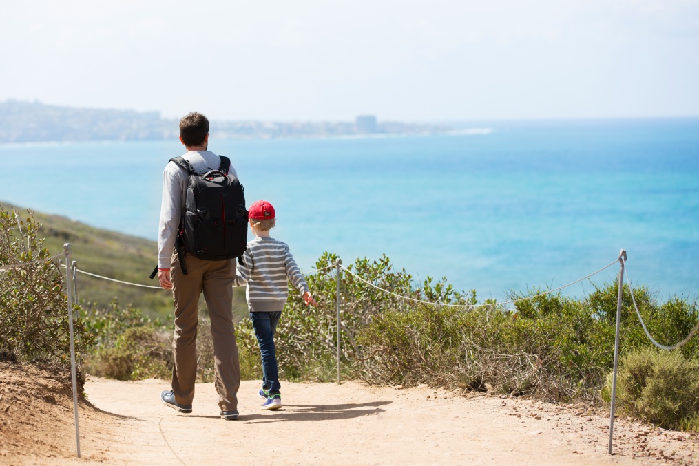 young active family of two hiking in torrey pines state natural reserve, concept of active and healthy lifestyle