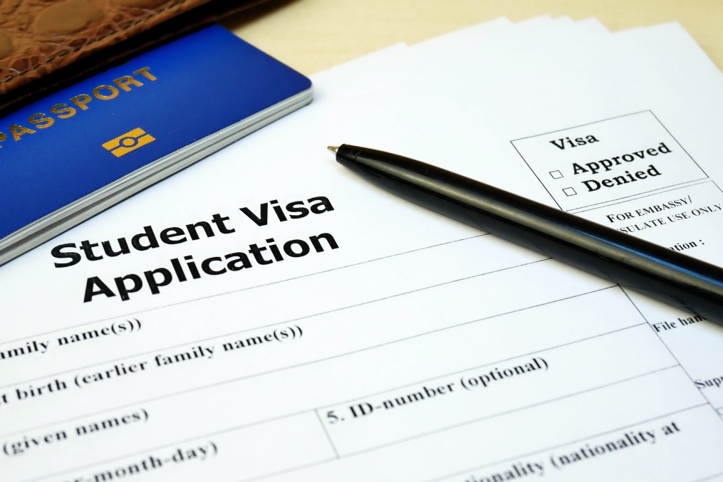 Student Visa application form with passport and pen. Document with passport, apply and permission for foreigner country