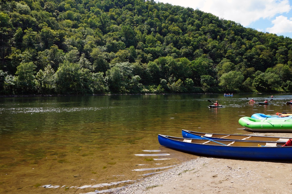 Kayakers in the Delaware River and Canoes and Rafts on the Shore at the Delaware Water Gap in Pennsylvania