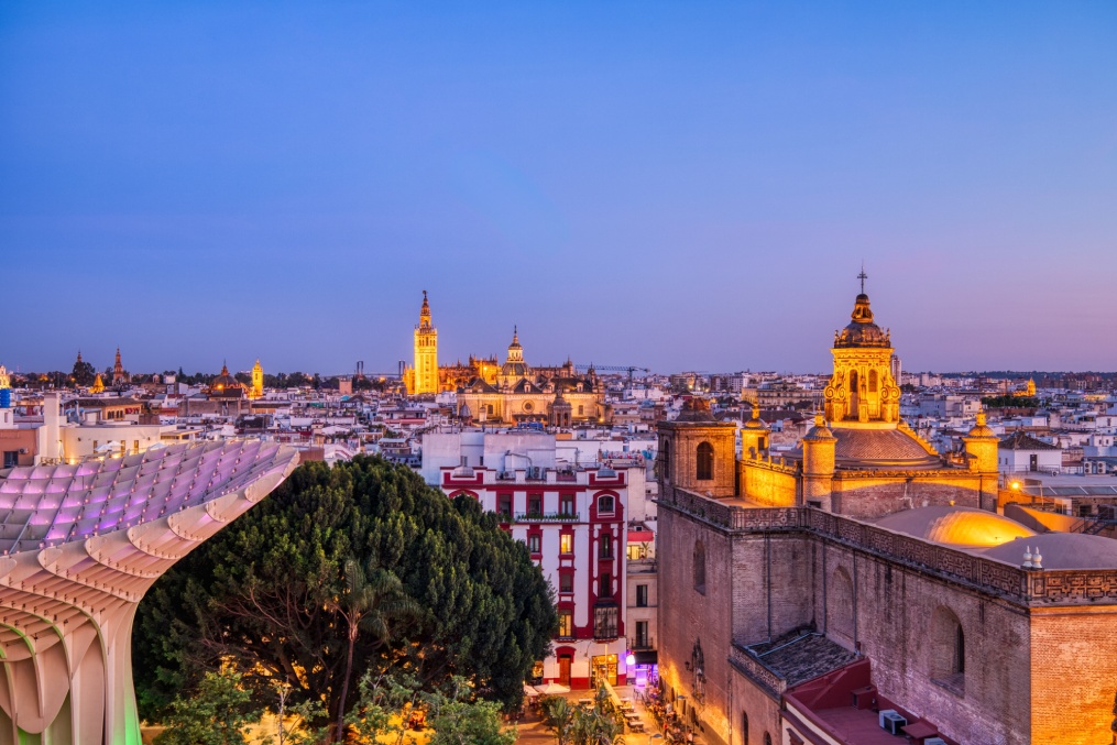 Seville City Skyline view with Illuminated Space Metropol Parasol in the Foreground at Dusk, Seville, Spain