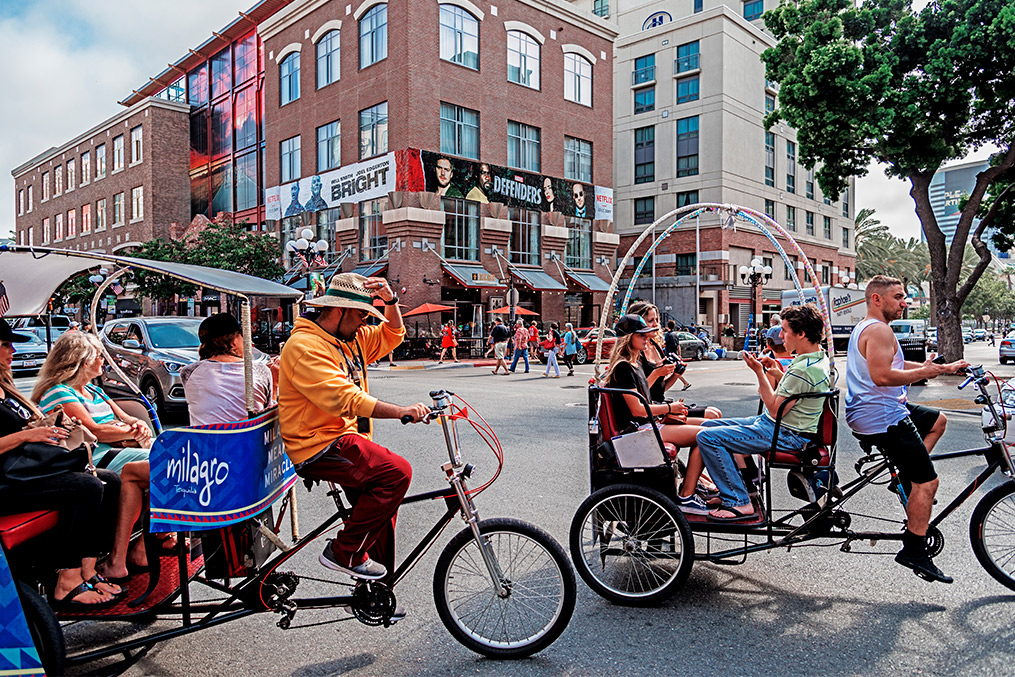 Several people biking along a lively city street in San Diego, showcasing summer activities in 2025.