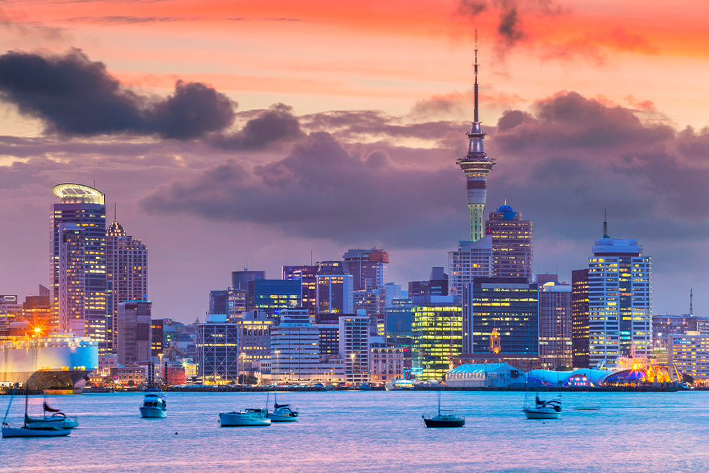Sunset over Auckland's skyline, highlighting the city's architecture and beauty, ideal for those moving to New Zealand.