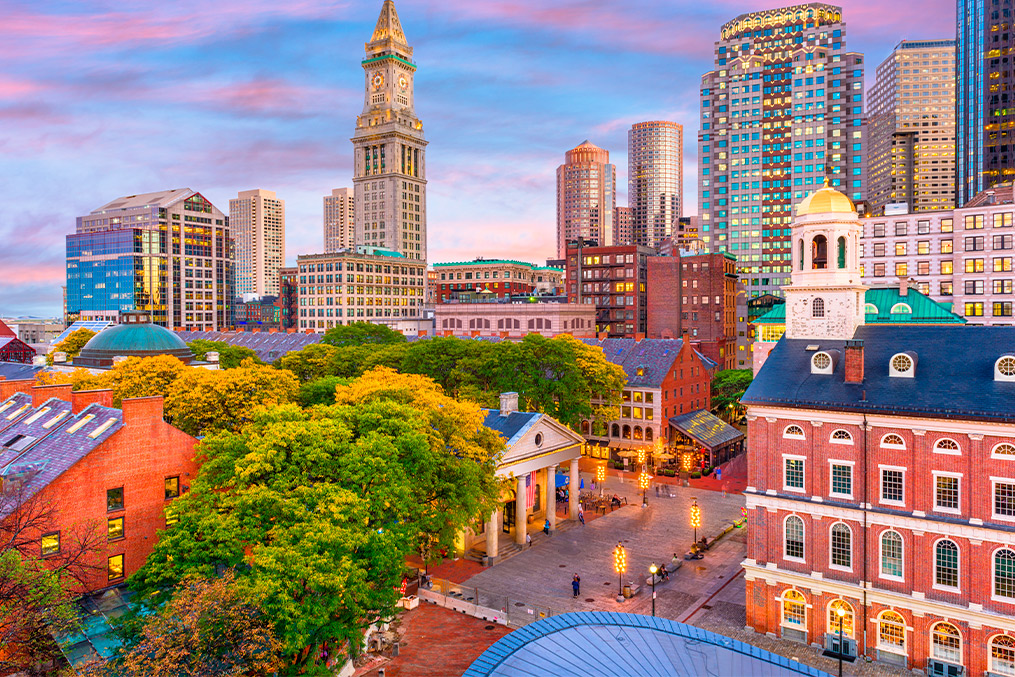 Panoramic view of Boston, Massachusetts, at sunset, highlighting the blend of historic and modern architecture.