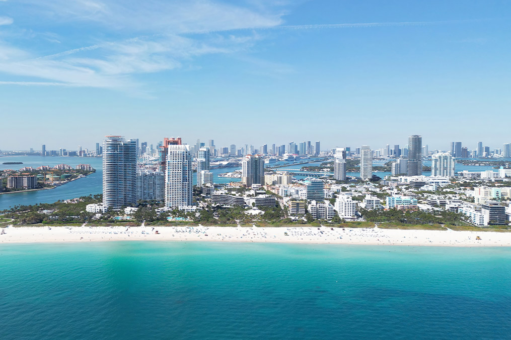 A panoramic view of Miami's beach alongside its modern skyline, highlighting the city's coastal charm and architecture.