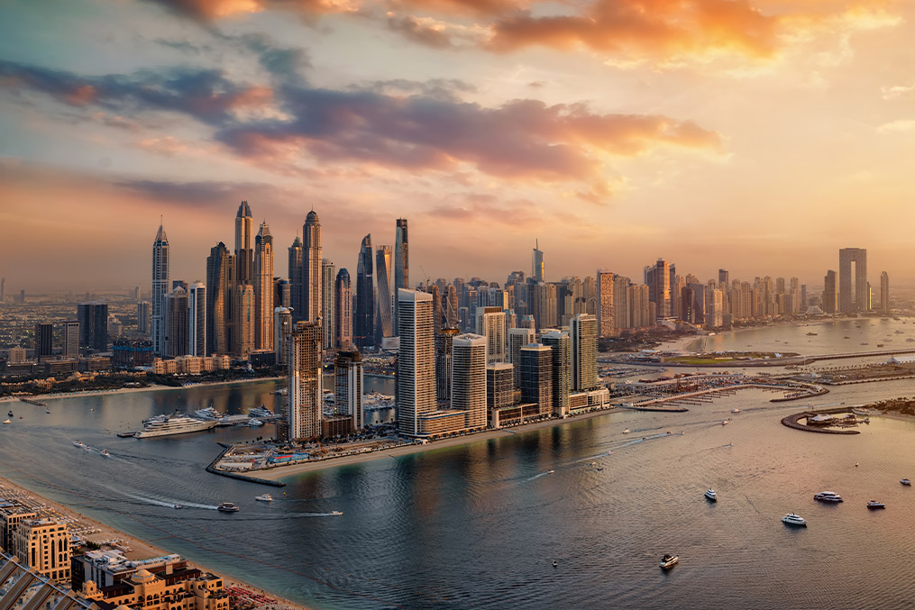 Sunset over Dubai's skyline, highlighting modern architecture and a colorful sky, featured in a Middle East living guide.