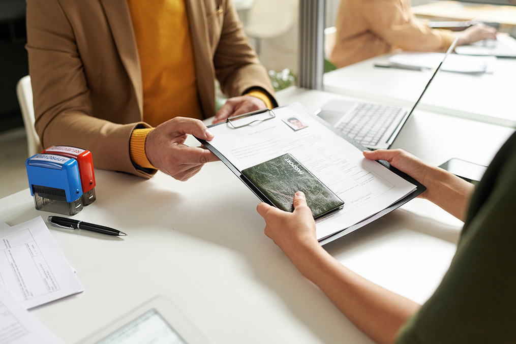  A man and woman are seated at a table with a laptop, exploring information on relocating from California to Dubai.