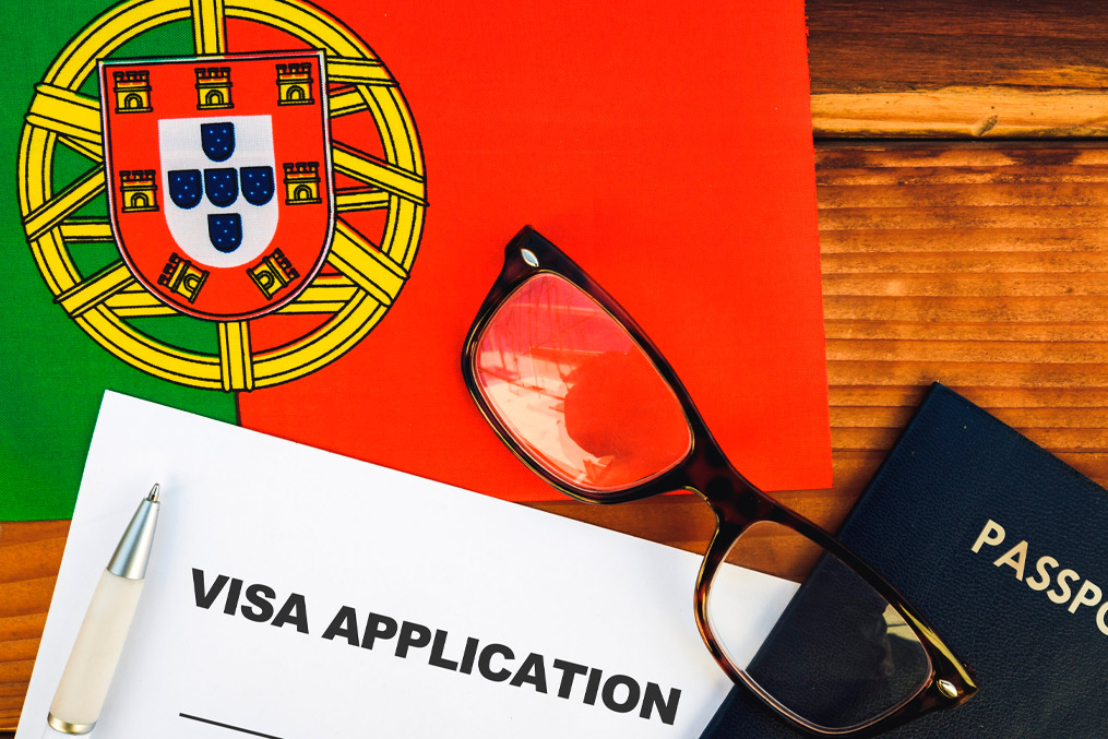 Flag of Portugal , visa application form and passport on table