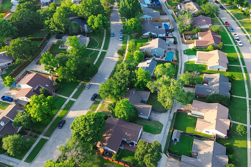 winding streets, single-family homes with private yards, and mature trees.