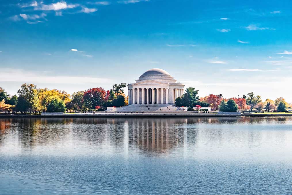 Peaceful autumn scenery with Jefferson Memorial across reflective water in Washington DC