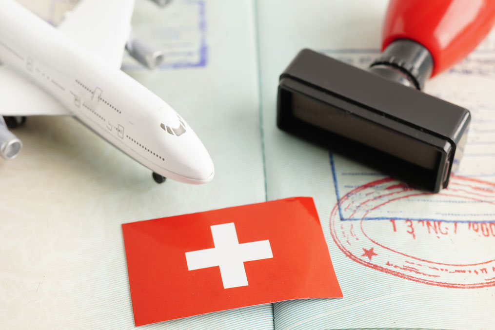 Switzerland flag and passport with airplane for travel.