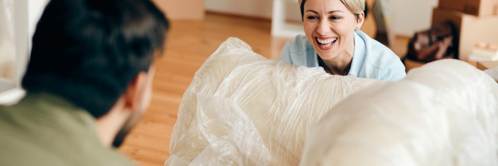 Couple moving a couch.